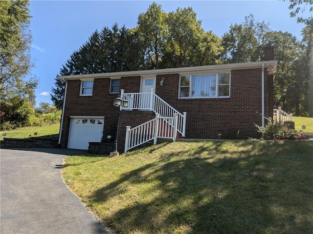 view of front of property with a garage and a front yard