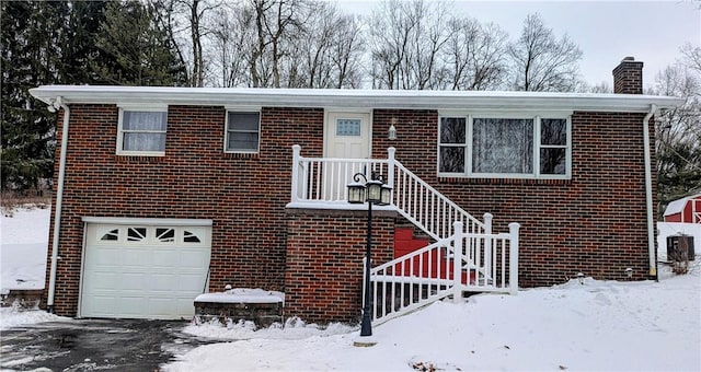 view of front facade featuring a garage and cooling unit