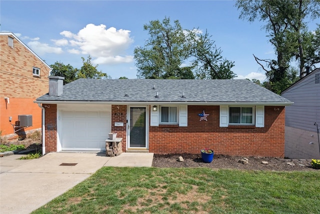 view of front of house featuring a garage, central AC unit, and a front lawn