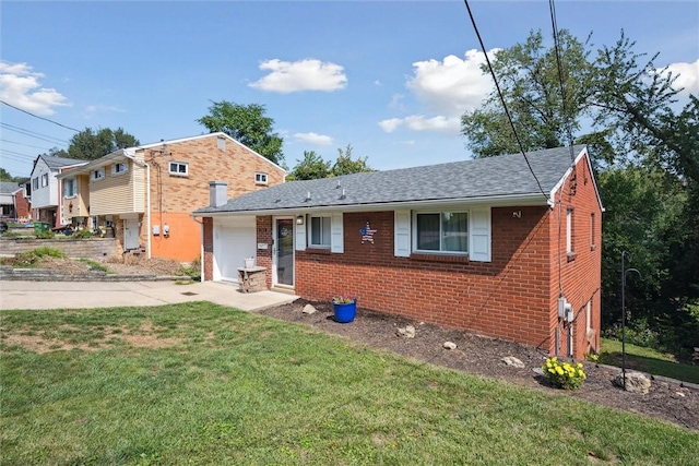 view of front facade featuring brick siding, an attached garage, concrete driveway, and a front yard