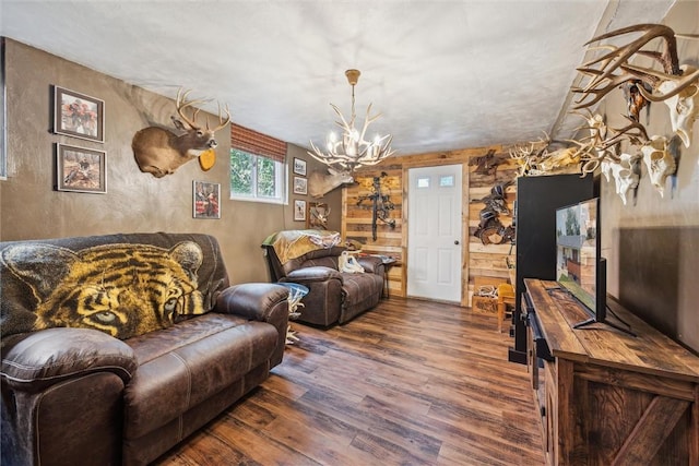 living area featuring dark wood-style floors and a notable chandelier