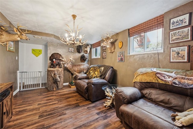 interior space featuring baseboards, wood finished floors, and a chandelier