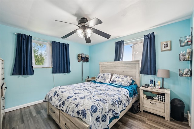 bedroom with ceiling fan and dark hardwood / wood-style flooring