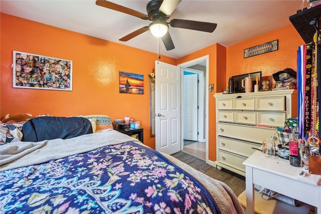 bedroom featuring wood finished floors and a ceiling fan