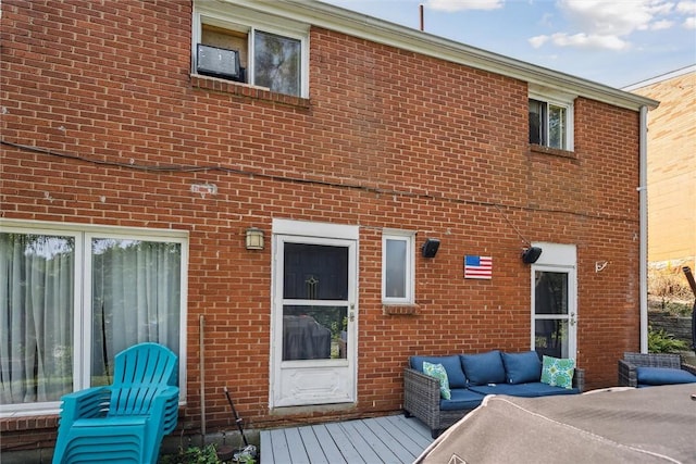 back of house with brick siding and outdoor lounge area