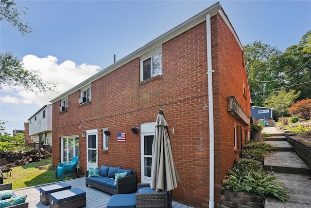 rear view of house with brick siding and an outdoor living space