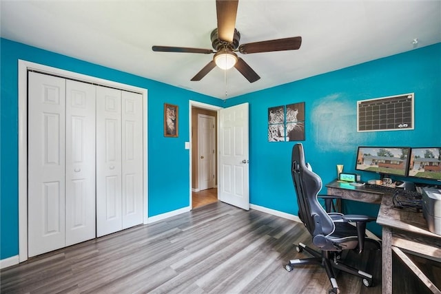 office space featuring wood finished floors, baseboards, and ceiling fan