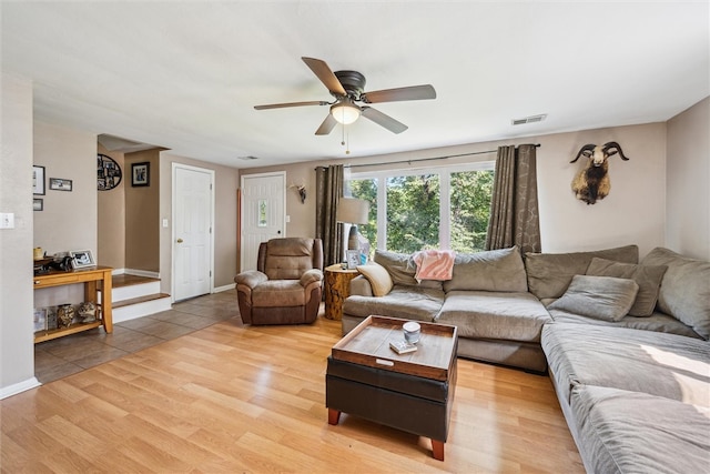 living room featuring ceiling fan and light wood-type flooring