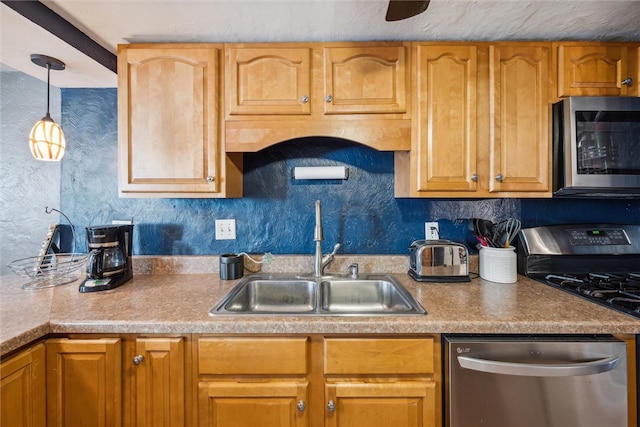 kitchen with pendant lighting, sink, appliances with stainless steel finishes, and decorative backsplash