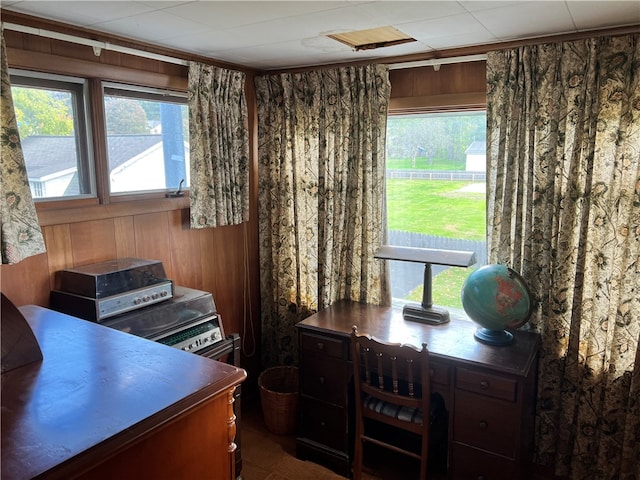 home office with wooden walls and ornamental molding