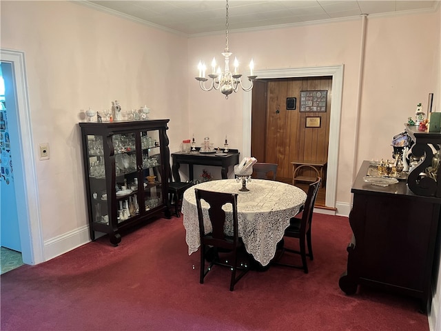 dining area featuring ornamental molding, dark colored carpet, and a notable chandelier