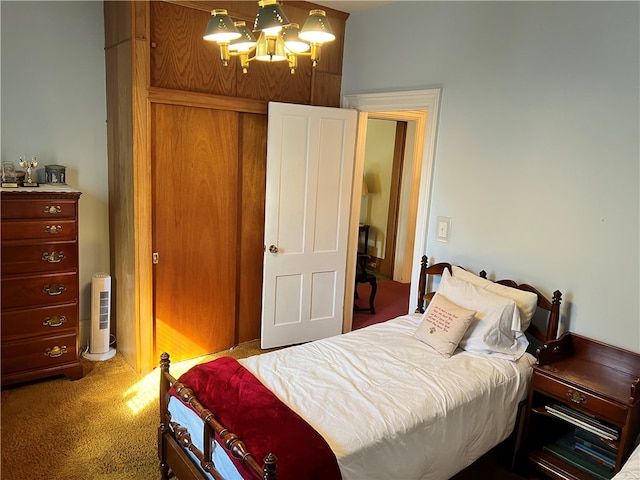 carpeted bedroom with a notable chandelier