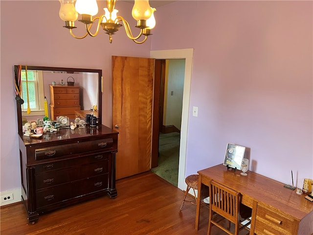 interior space with dark wood-type flooring and a notable chandelier