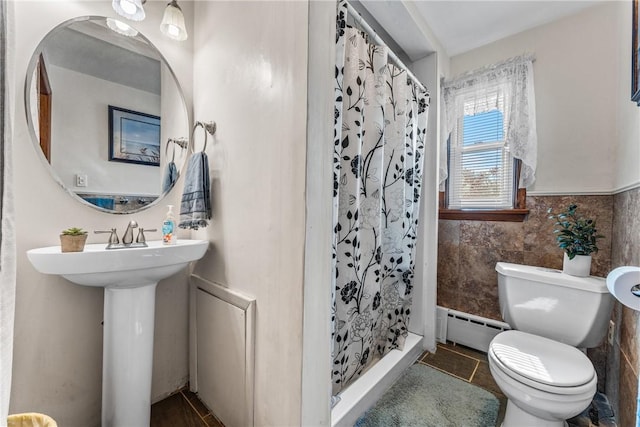 bathroom featuring tile walls, tile patterned flooring, walk in shower, baseboard heating, and toilet