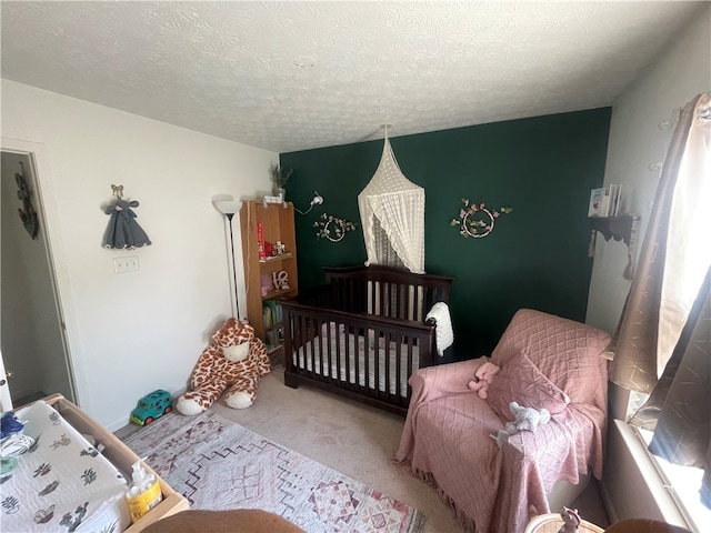 bedroom featuring carpet floors and a textured ceiling