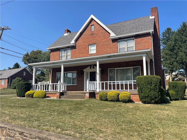 view of front facade featuring a front lawn and a porch