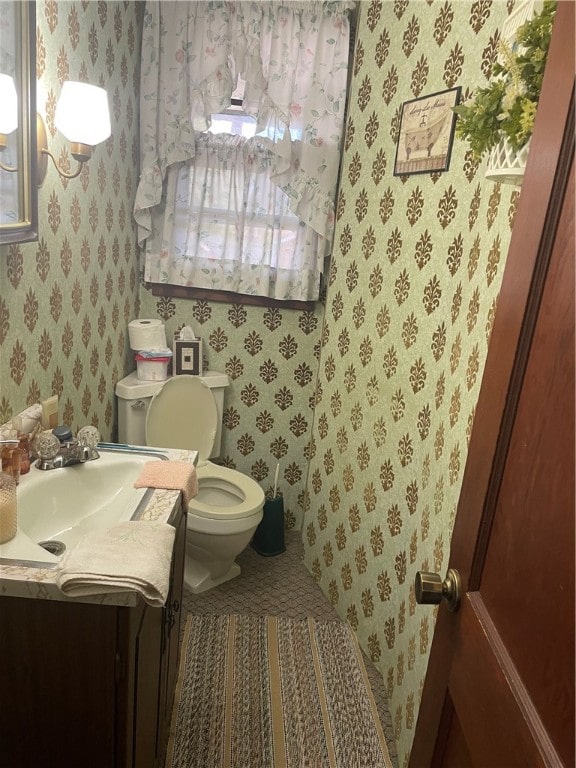 bathroom featuring vanity and toilet