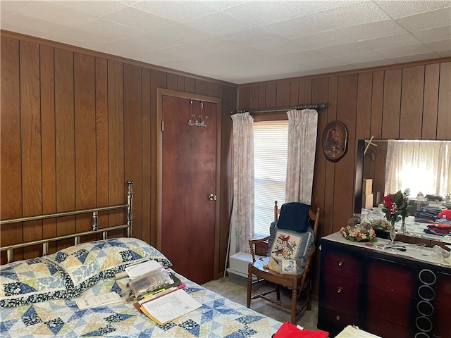 bedroom featuring wood walls