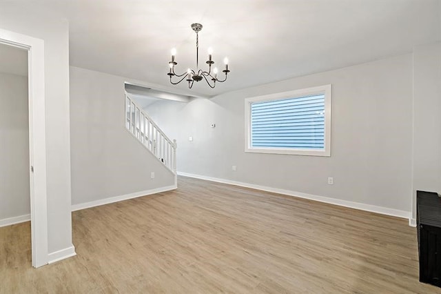 interior space featuring light hardwood / wood-style floors and a notable chandelier