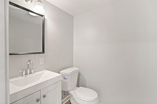 bathroom with toilet and vanity