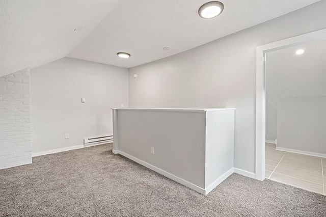 bonus room featuring a baseboard heating unit, vaulted ceiling, and light carpet