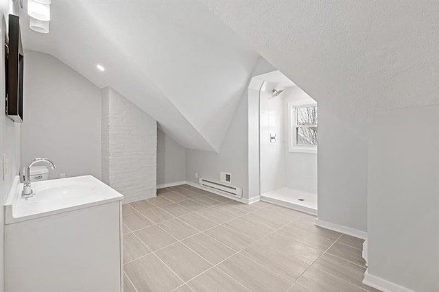 bathroom featuring walk in shower, tile patterned floors, vanity, a textured ceiling, and vaulted ceiling