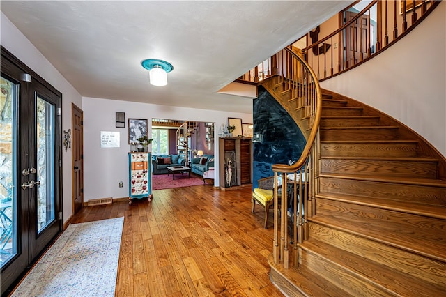 foyer with a healthy amount of sunlight and wood-type flooring