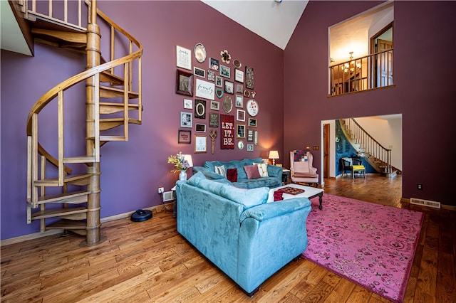 living room featuring high vaulted ceiling and hardwood / wood-style flooring