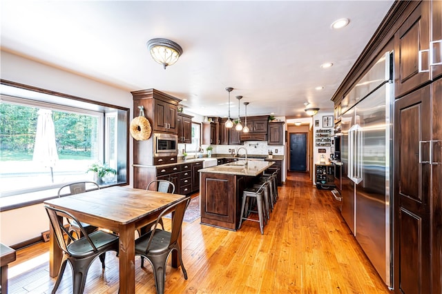 dining room with light hardwood / wood-style flooring and sink