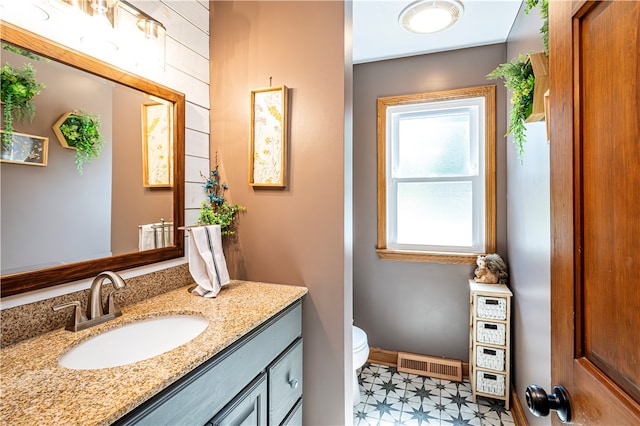 bathroom featuring vanity and toilet