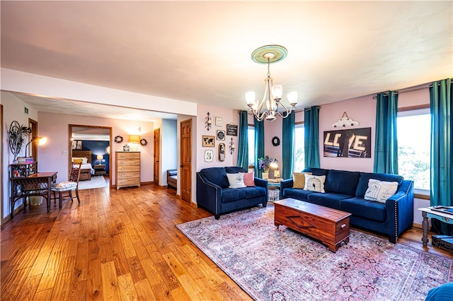 living room with a notable chandelier and hardwood / wood-style floors