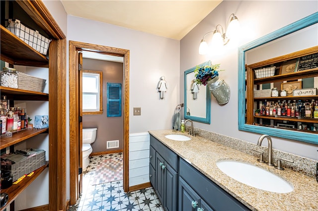 bathroom featuring toilet and vanity