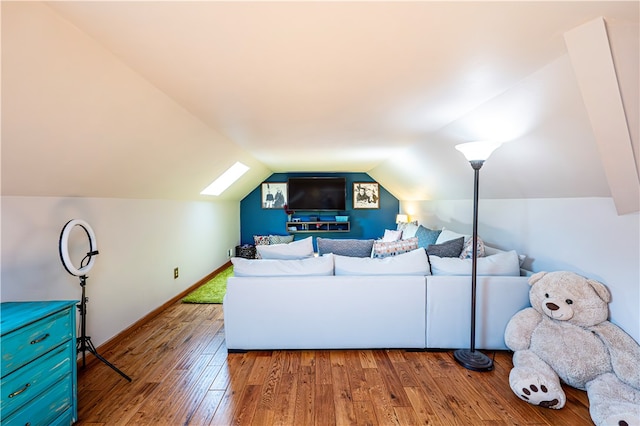 living room with vaulted ceiling and hardwood / wood-style floors