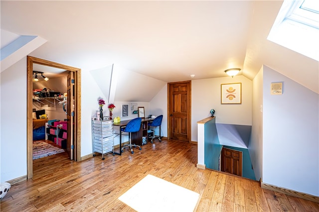 office area featuring lofted ceiling and light hardwood / wood-style flooring