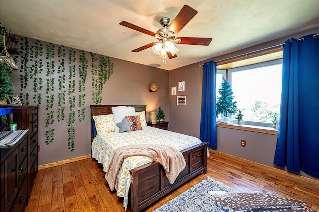 bedroom featuring hardwood / wood-style floors and ceiling fan