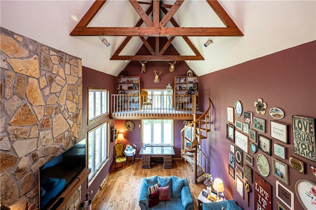 living room with beam ceiling, high vaulted ceiling, and hardwood / wood-style flooring