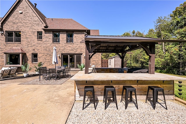 view of patio featuring a gazebo and an outdoor bar