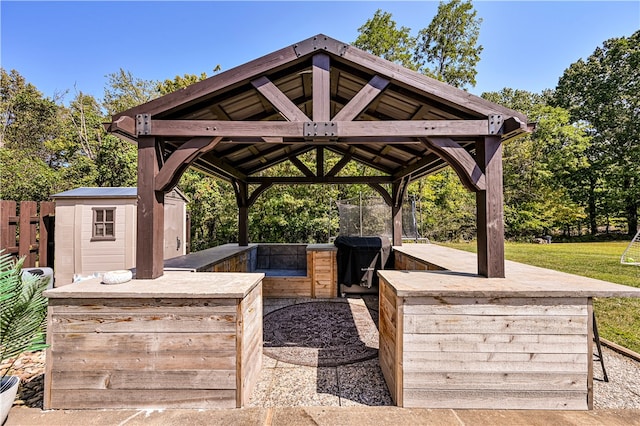 view of patio / terrace with area for grilling, a gazebo, and a storage shed