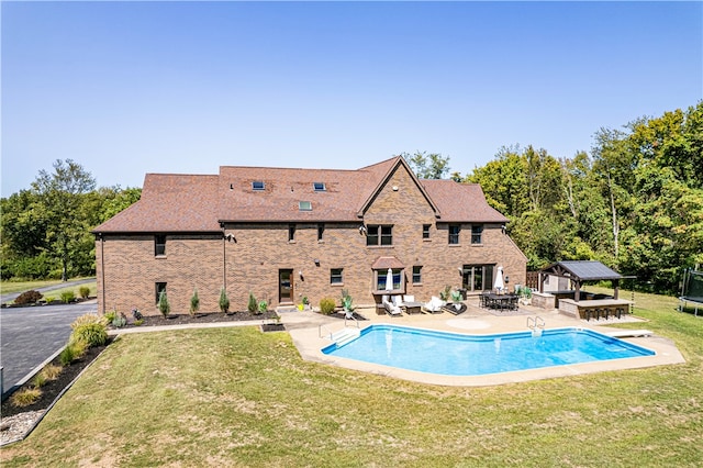 view of pool featuring a diving board, a lawn, a patio, and a gazebo