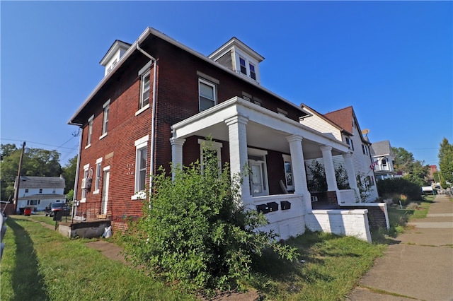 view of side of property featuring a porch