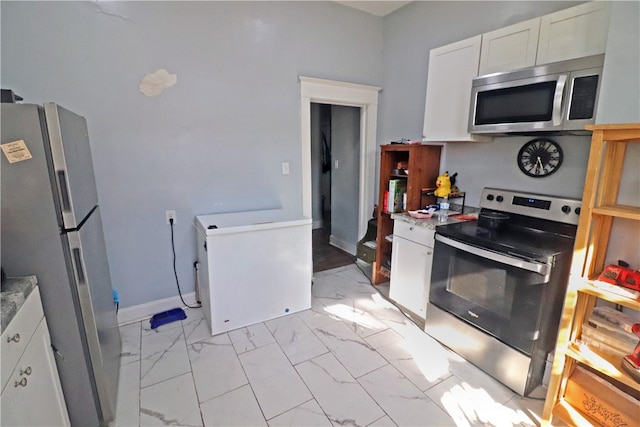 kitchen with stainless steel appliances and white cabinetry