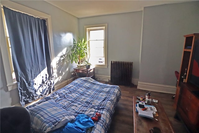 bedroom featuring radiator and dark hardwood / wood-style floors