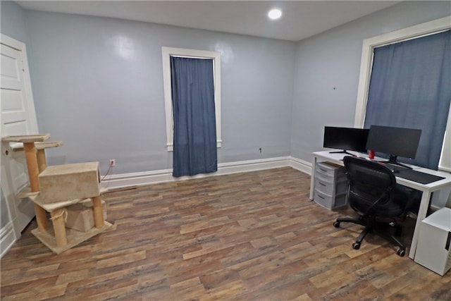 home office with dark hardwood / wood-style floors