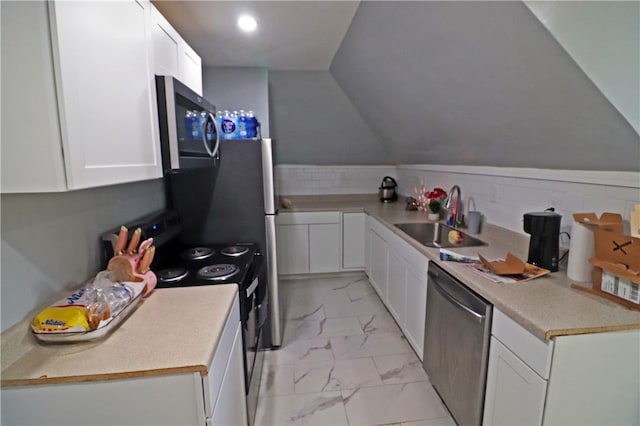 kitchen with tasteful backsplash, sink, appliances with stainless steel finishes, lofted ceiling, and white cabinets