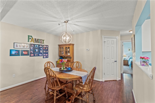 dining room with an inviting chandelier, dark hardwood / wood-style flooring, and a textured ceiling