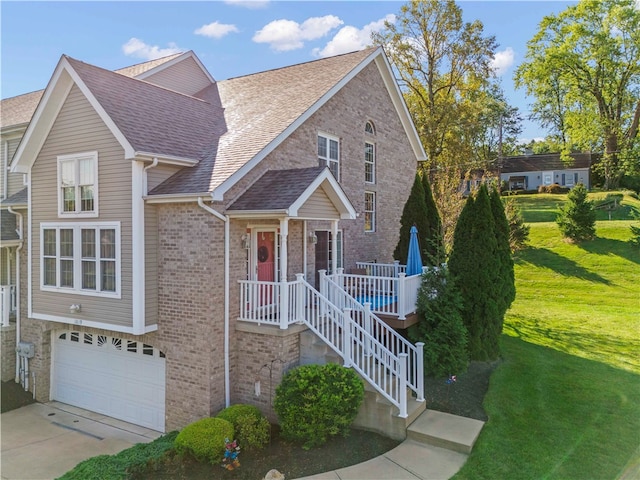 view of front of house with a garage and a front lawn