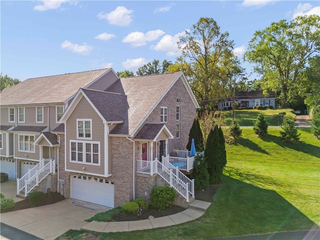 view of front of property with a garage, a front yard, and a porch