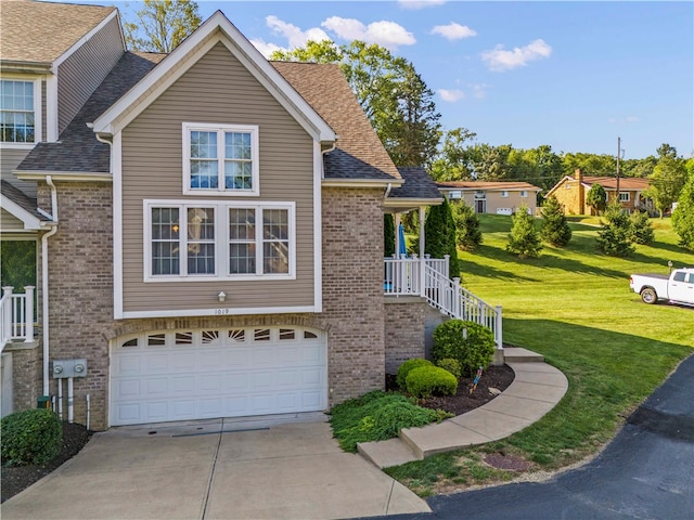 view of front of property featuring a front yard and a garage