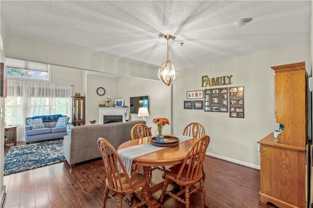 dining space with a chandelier, dark hardwood / wood-style flooring, and a textured ceiling