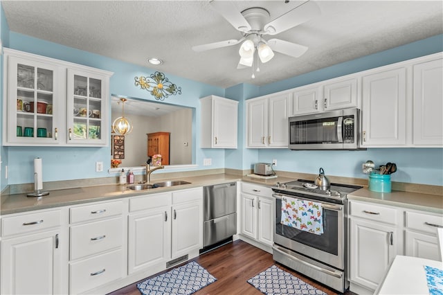 kitchen with stainless steel appliances, white cabinetry, sink, dark wood-type flooring, and ceiling fan